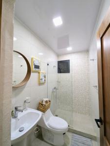 a bathroom with a toilet and a sink and a shower at Marbella in San Felipe de Puerto Plata