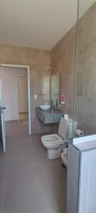 a bathroom with a toilet and a sink at Dormis Sinsacate in Sinsacate