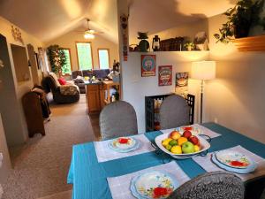 a dining room table with a bowl of fruit on it at Soldotna Alaska 1 bedroom Split Level Guesthouse in Soldotna