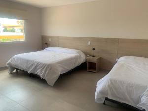 a bedroom with two beds and a window at Dormis Sinsacate in Sinsacate