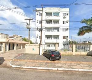 a car parked in a parking lot in front of a building at Aconchego no Solar do Coqueiro in Ananindeua