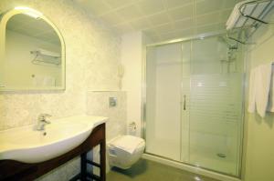 a bathroom with a sink and a shower and a toilet at Pasa Garden Beach in Marmaris +17 photos