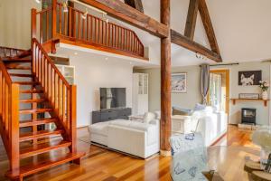 a living room with a wooden staircase and a white couch at Bickley Tree Stay in Bickley
