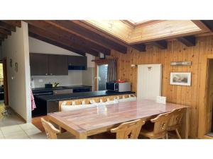 a kitchen with a large wooden table and chairs at Apartment in Veysonnaz near Ski Lift in Agettes