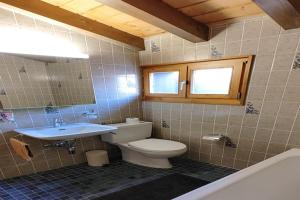a bathroom with a toilet and a sink at Apartment in Veysonnaz near Ski Lift in Agettes +24 photos