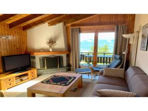 a living room with a couch and a tv at Apartment in Veysonnaz near Ski Lift in Agettes