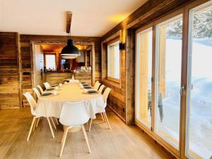 a dining room with a long table and chairs at Chalet in 4 Vallées with Ski-In Access in Les Collons +32 photos
