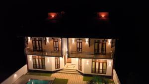 a model of a house with a pool at night at Villa Elegant Oasis in Horana +4 photos