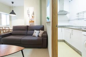 un salon avec un canapé et une table dans l'établissement Apartamentos Alberto Lista 9, à Séville