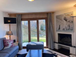 a living room with a couch and a fireplace at Apartment in Veysonnaz with Private Balcony in Veysonnaz
