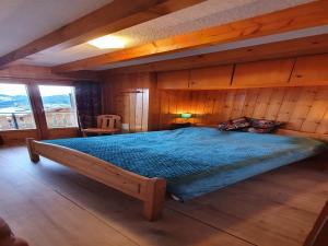 un letto grande in una stanza con pareti di legno di Chalet in Veysonnaz with valley view a Veysonnaz