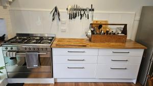 a kitchen with a stove and a white counter top at 'The Gardenia' Trentham in Trentham +31 photos