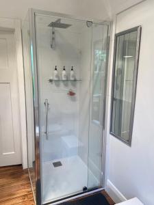 a shower with a glass door in a bathroom at 'The Gardenia' Trentham in Trentham