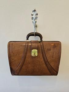 a brown briefcase hanging from a wall at 'The Gardenia' Trentham in Trentham