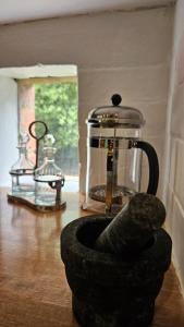 a tea kettle and a bowl on a wooden floor at 'The Gardenia' Trentham in Trentham
