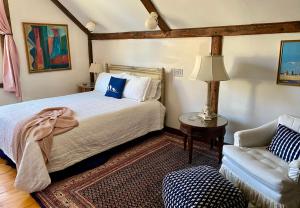a bedroom with a bed and a couch at Charming 4BR colonial close to downtown in Keene