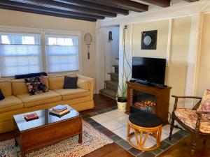 a living room with a couch and a fireplace at Charming 4BR colonial close to downtown in Keene