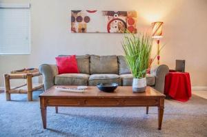 a living room with a couch and a coffee table at Longer Stays for Travelers- Apt Blocks from Hospital, Downtown in Visalia