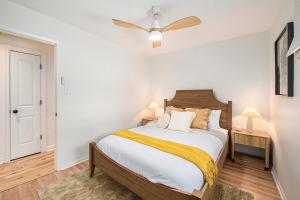 a bedroom with a bed and a ceiling fan at New Beach front 5bd in Sister Lakes with Hot tub in Dowagiac