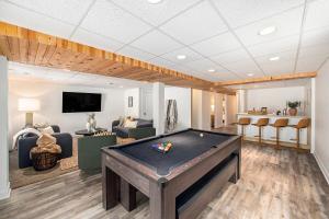 a living room with a pool table in it at New Beach front 5bd in Sister Lakes with Hot tub in Dowagiac