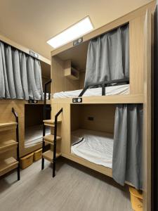 a room with two bunk beds in a dorm room at First Villa Life Hostel in Ban Na Song +33 photos