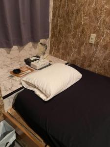Postel nebo postele na pokoji v ubytování ホテル サンガ