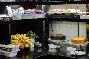 a buffet with different types of food on display at Hotel Aero Sleep Campinas in Campinas