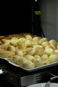 a pan of doughnuts sitting on top of a stove at Hotel Aero Sleep Campinas in Campinas