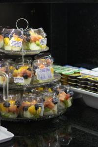 a display of different types of fruit in plastic containers at Hotel Aero Sleep Campinas in Campinas +26 photos
