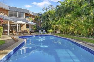 an image of a swimming pool in front of a house at Your Noosa HQ - modern apartment near everything! in Noosaville