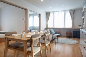 a dining room with a table and chairs at TKD HOUSE Furano 2 in Furano
