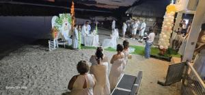a group of people in white dresses standing around a ceremony at EDVIL BEACH RESORT in Padre Burgos +87 photos