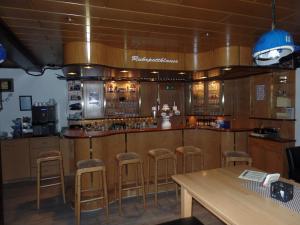 a bar with bar stools in a restaurant at Hotel Vogt in Bad Driburg