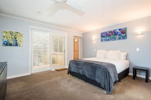 a bedroom with a bed and a television in it at Driftwood By Khove in Gold Coast