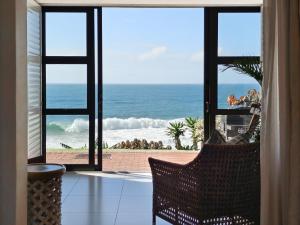 a room with a view of the ocean from a window at Benka Beach, Sheffield, KwaZulu Natal in Sheffield Beach