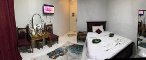 Voodi või voodid majutusasutuse Pharaohs Oasis Hotel toas