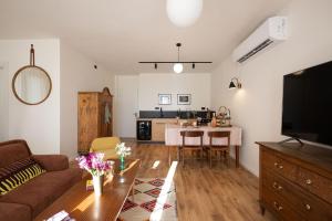 a living room with a couch and a table at Villa Hod Couples Suite with Hot Tub in Ein Hod