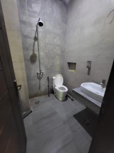 a bathroom with a toilet and a sink at Beautiful villa in bahria town karachi in Karachi