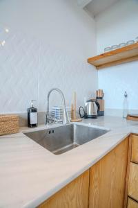 a kitchen counter with a stainless steel sink at Jiva Loft Style Villa in Canggu