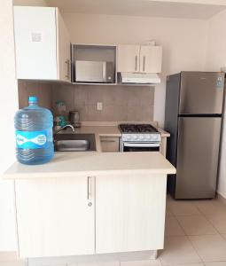a kitchen with a large bottle of water on the counter at Casas Marina Turquesa in Cancún +1 photo