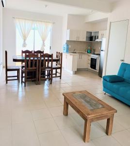 a living room with a blue couch and a table at Casas Marina Turquesa in Cancún
