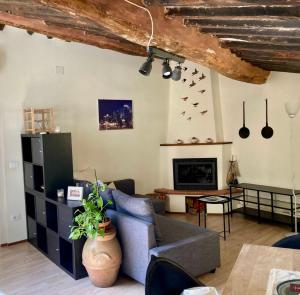 a living room with a couch and a fireplace at Dimora Leonardo. Centro Storico. in Lucca