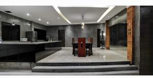 a kitchen with a counter and a table with chairs at Zaruchi Villa Argao in Argao