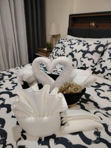 two swans made out of towels on a bed at Stylish New Studio at McKinley Hill BGC Free Netflix in Manila