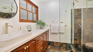 a bathroom with a sink and a shower at The Burrows of Penrose in Penrose +28 photos