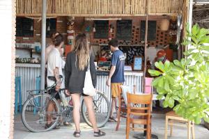 a group of people standing outside of a restaurant at EVA HUT Mui Ne Beach Hostel in Mui Ne