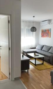 a living room with a couch and a table at For You in Vrnjci