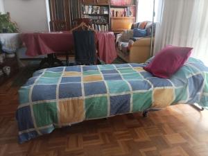 a bedroom with a bed with a colorful blanket at Habitacion Alameda de Osuna Madrid Aeropuerto in Madrid