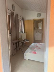a bedroom with a bed and a table in it at Casa Annalisa in Intragna