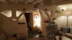 a living room with a hallway with a clock on the wall at Yr Hen Felin - The Old Mill B&B in Morfa Nefyn